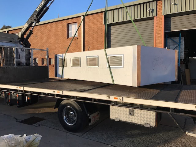 stainless steel exhaust hood getting delivered by a truck