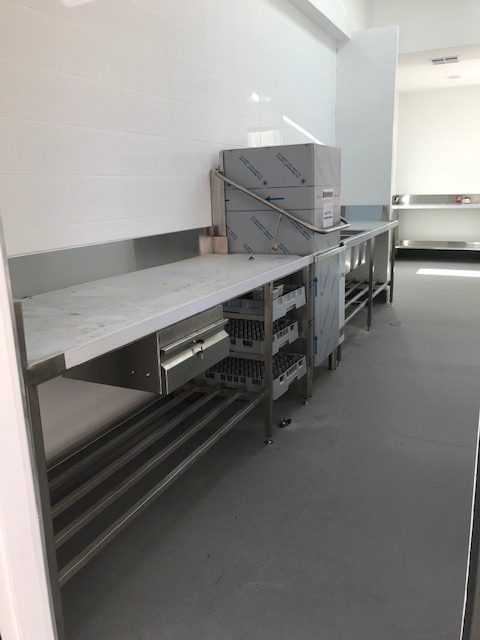 stainless kitchen counter, storage and dishwasher