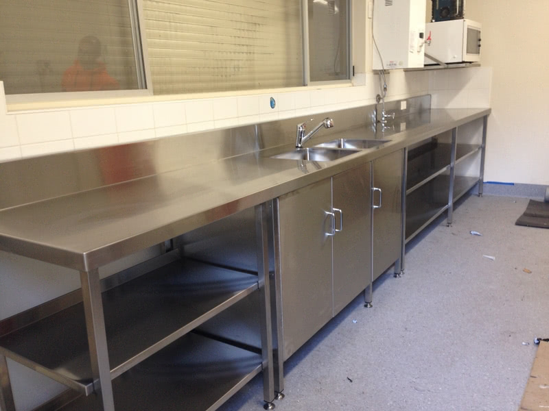 stainless steel bench with sink and storage racks